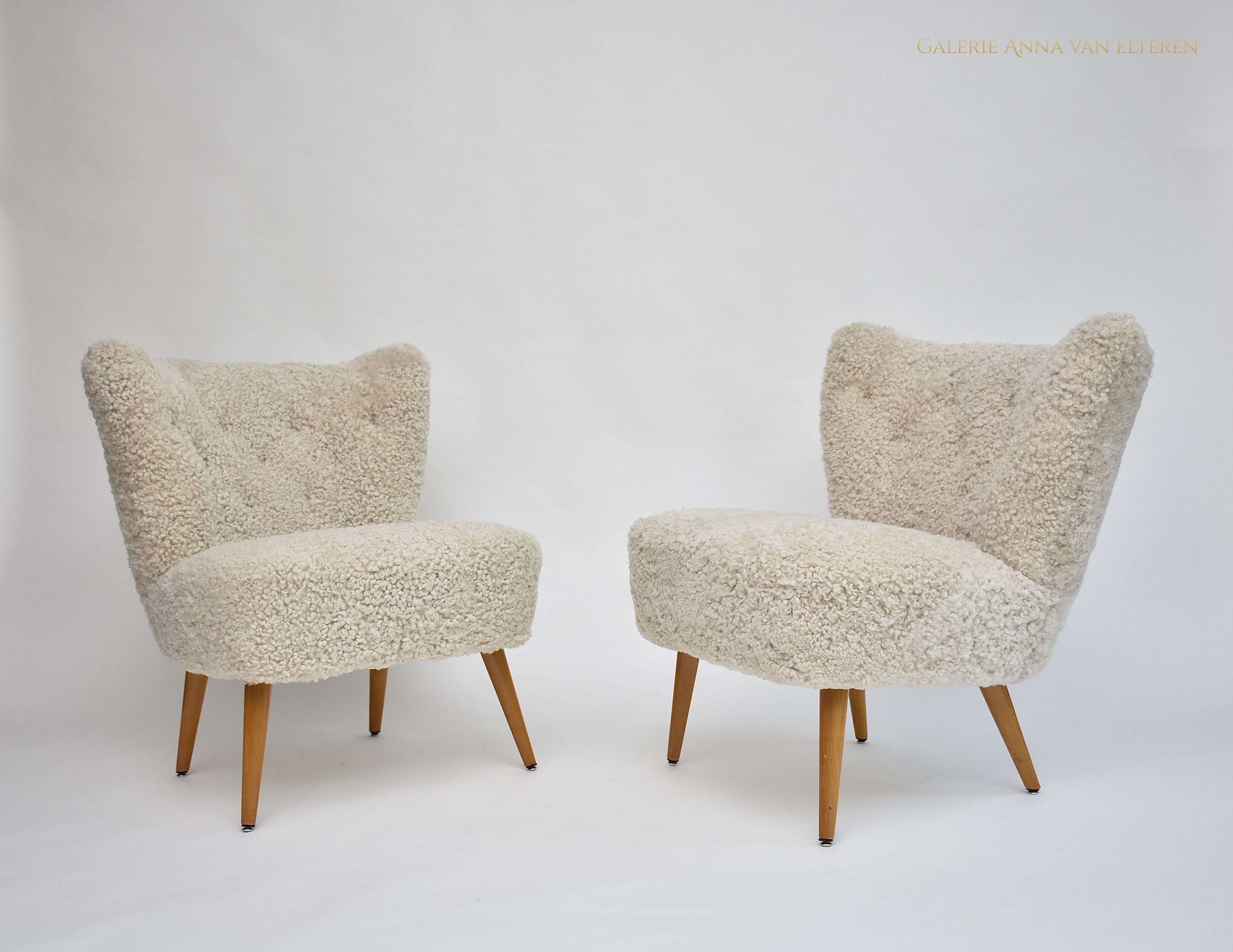 A pair of Swedish coctail or lounge armchairs in sheepskin