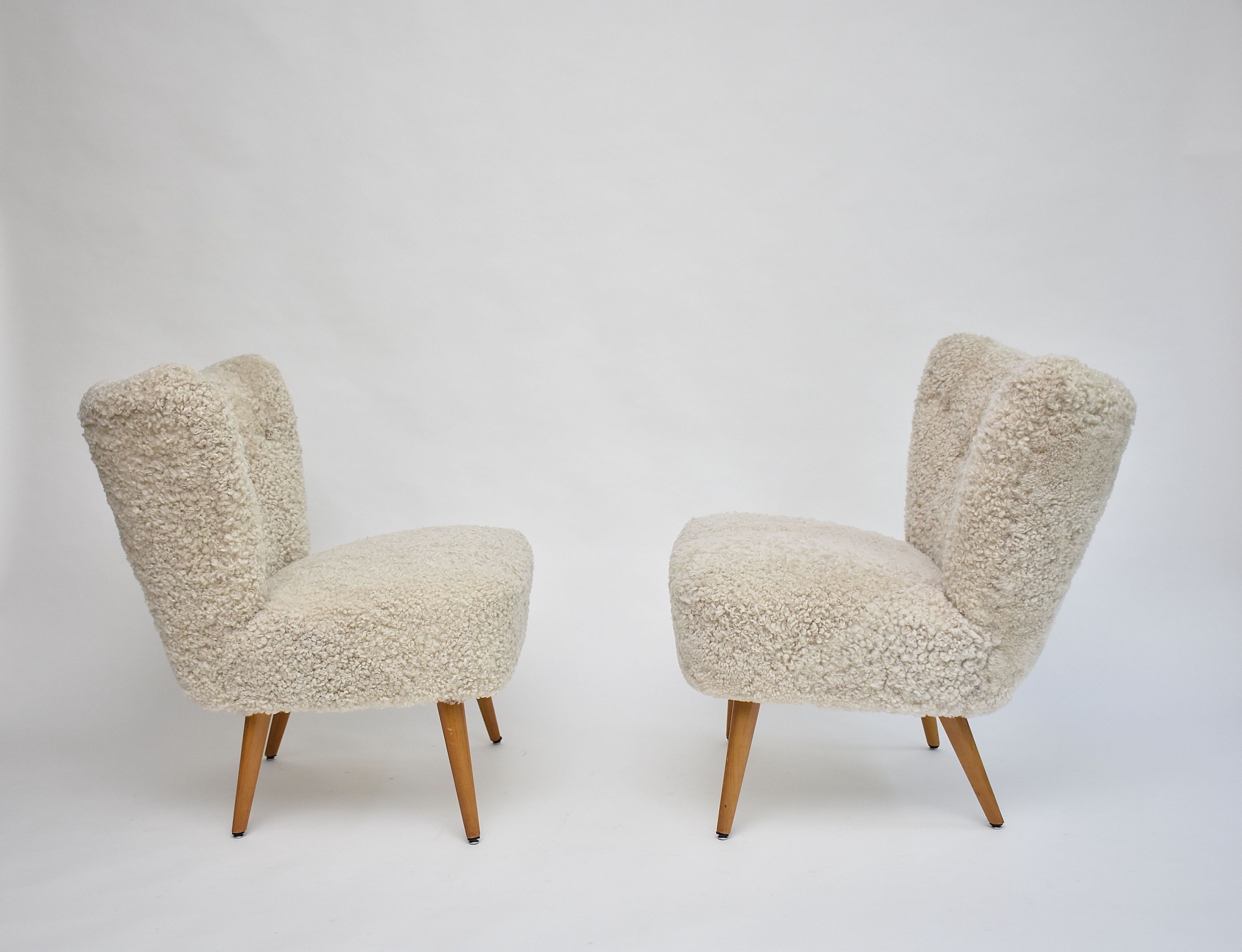 A pair of Swedish coctail or lounge armchairs in sheepskin