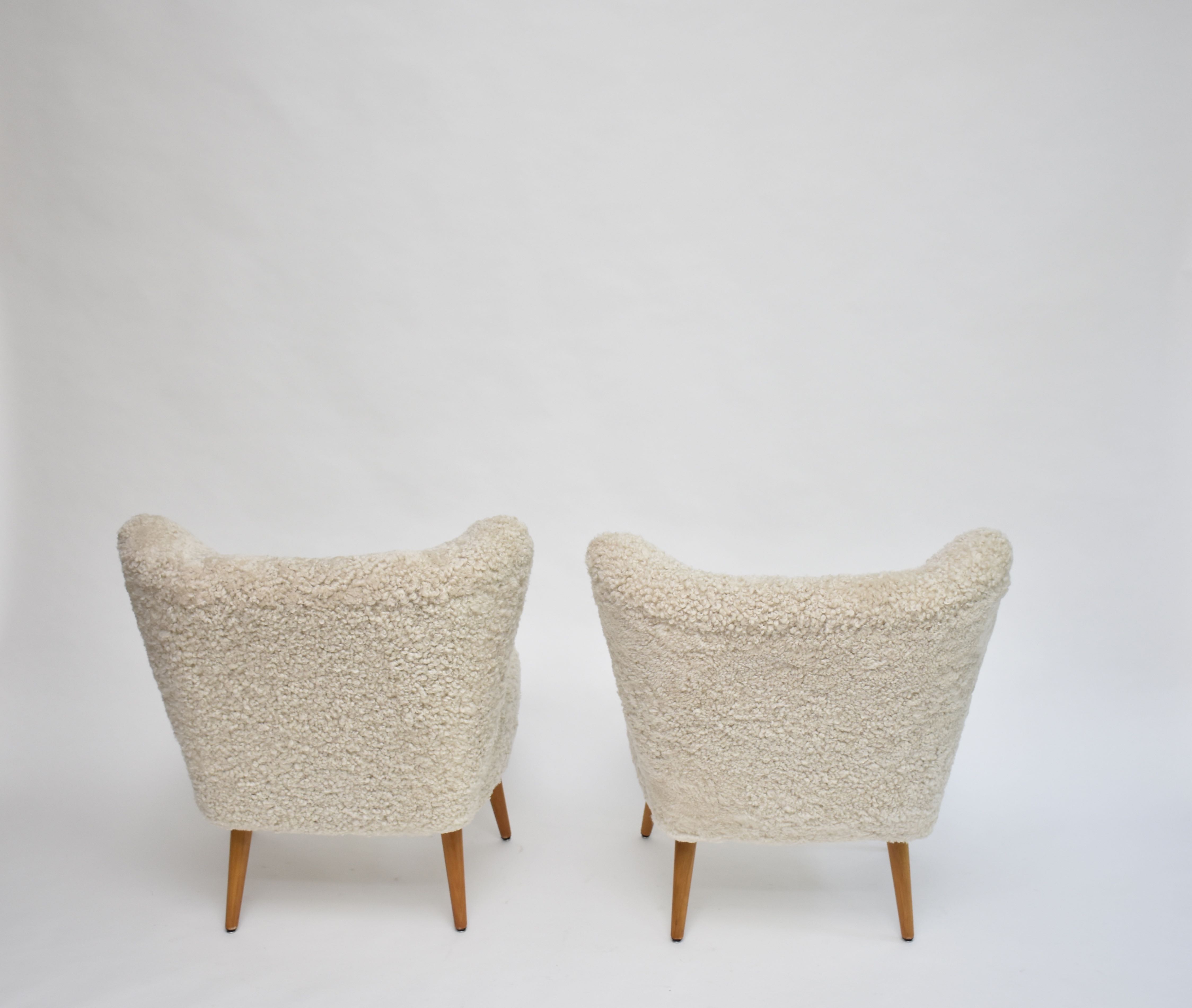 A pair of Swedish coctail or lounge armchairs in sheepskin