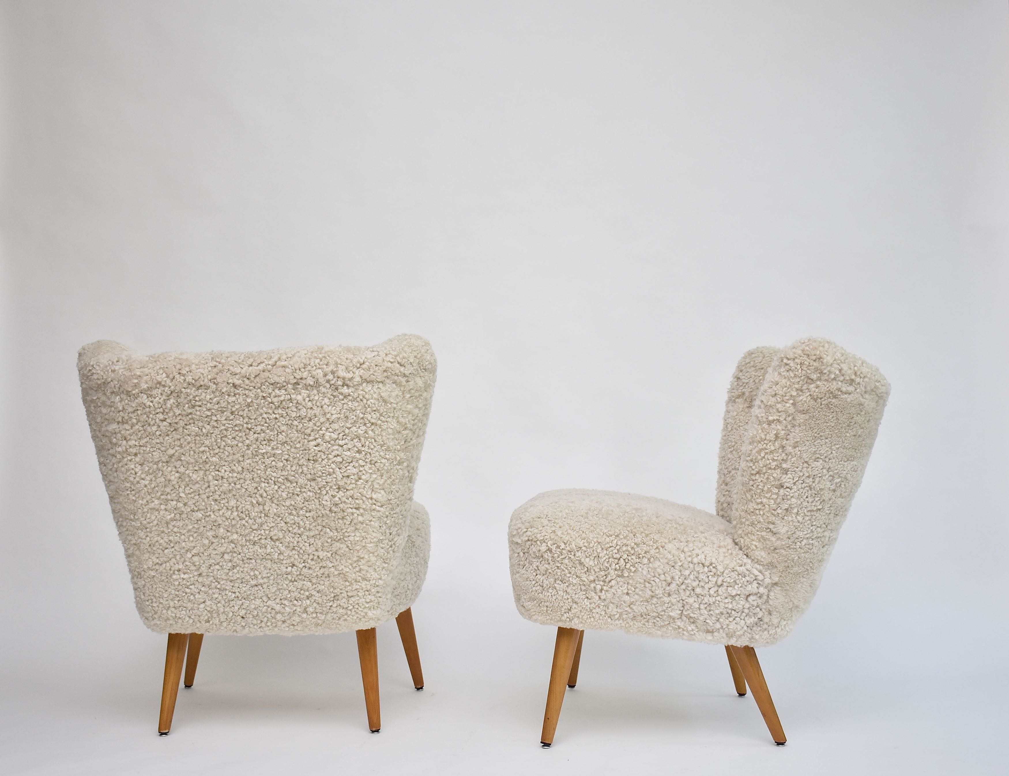 A pair of Swedish coctail or lounge armchairs in sheepskin