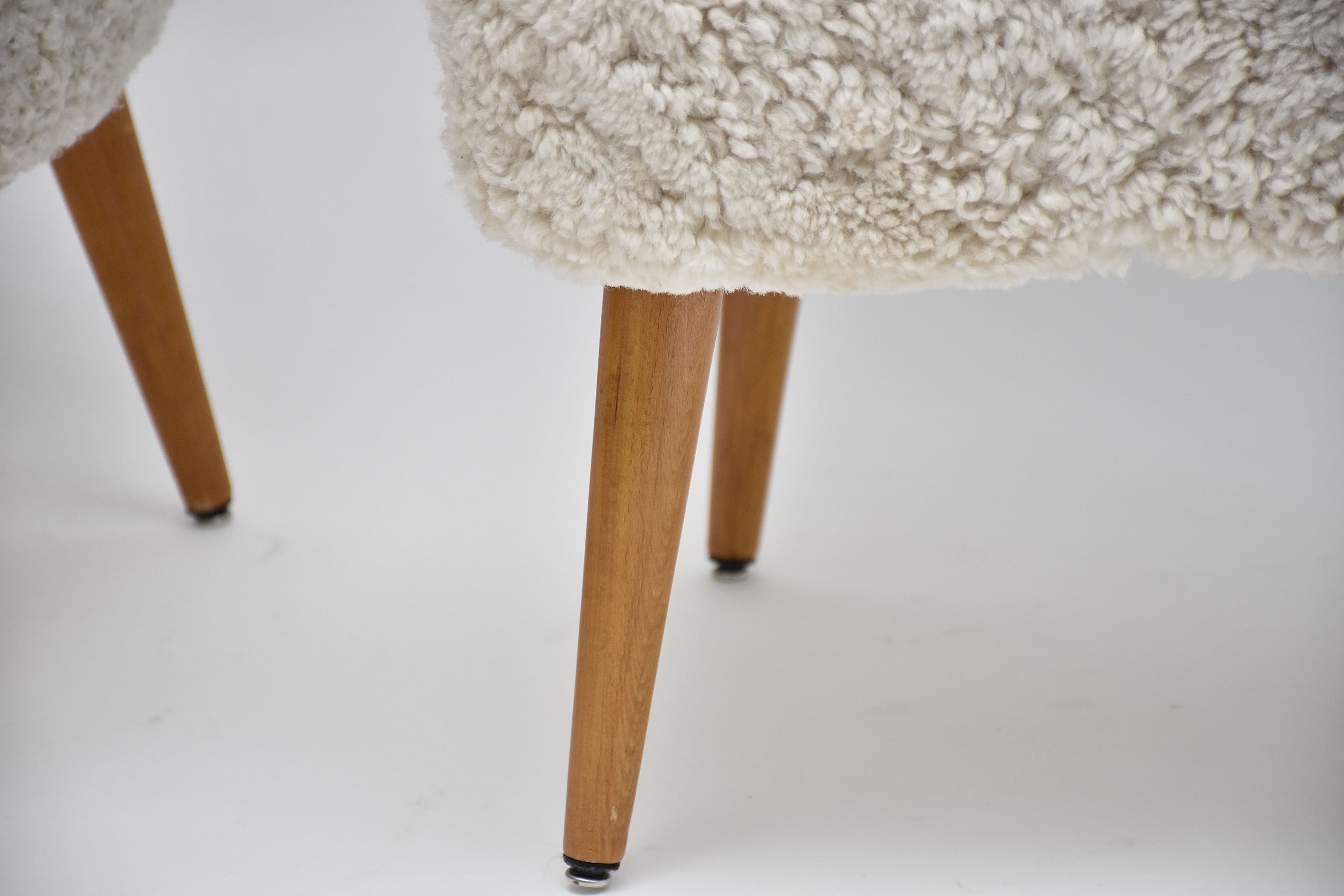 A pair of Swedish coctail or lounge armchairs in sheepskin