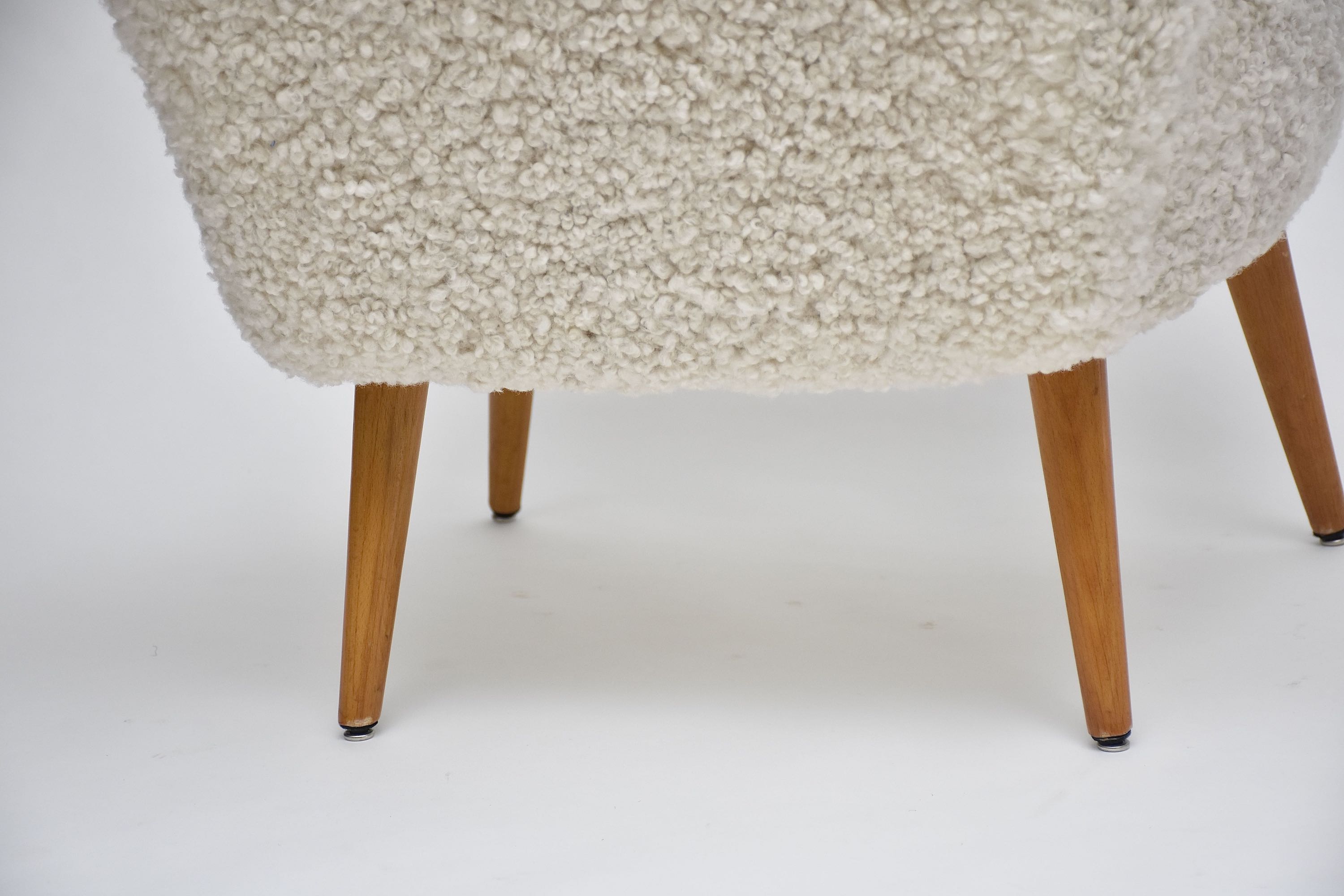 A pair of Swedish coctail or lounge armchairs in sheepskin