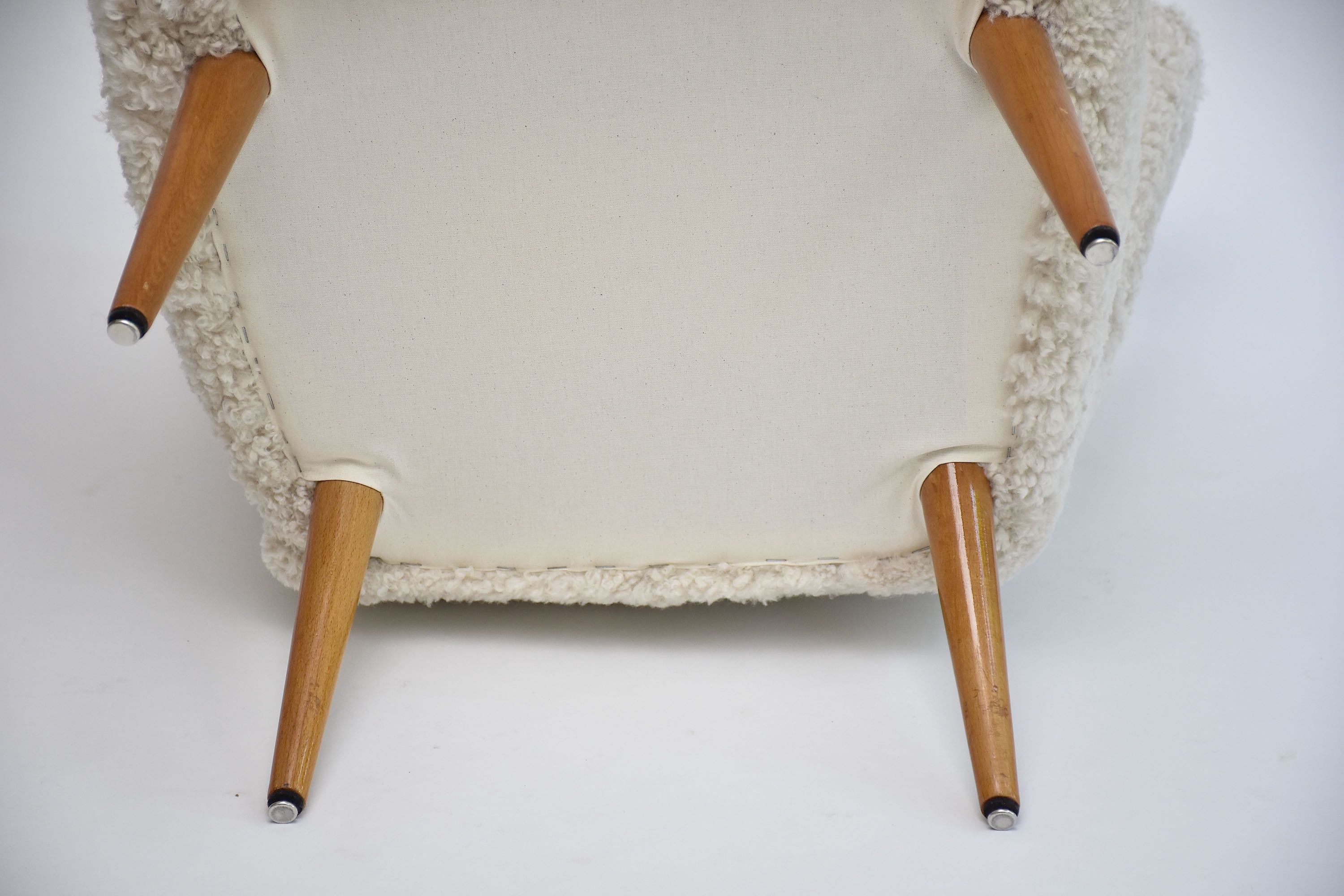 A pair of Swedish coctail or lounge armchairs in sheepskin