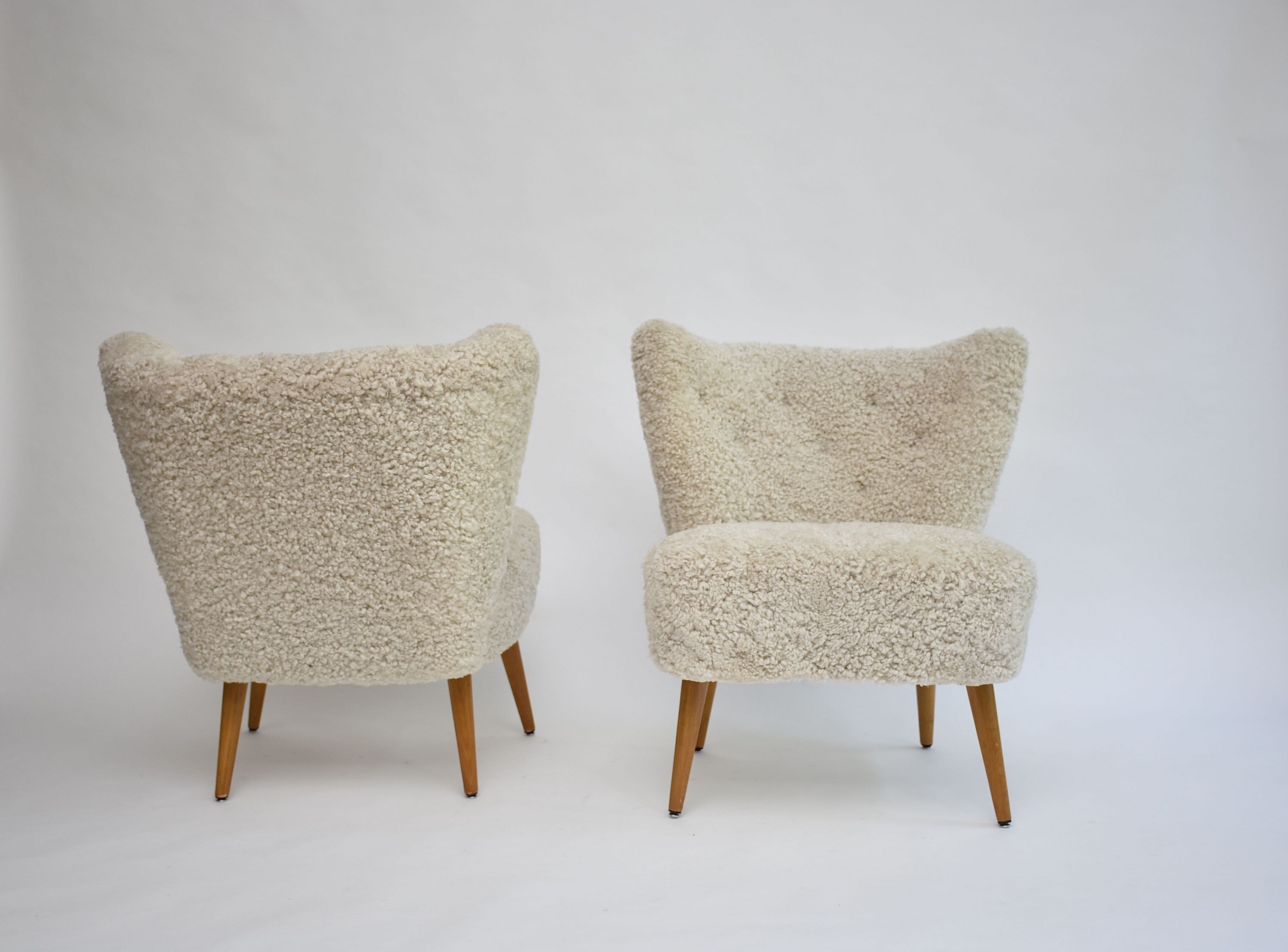 A pair of Swedish coctail or lounge armchairs in sheepskin