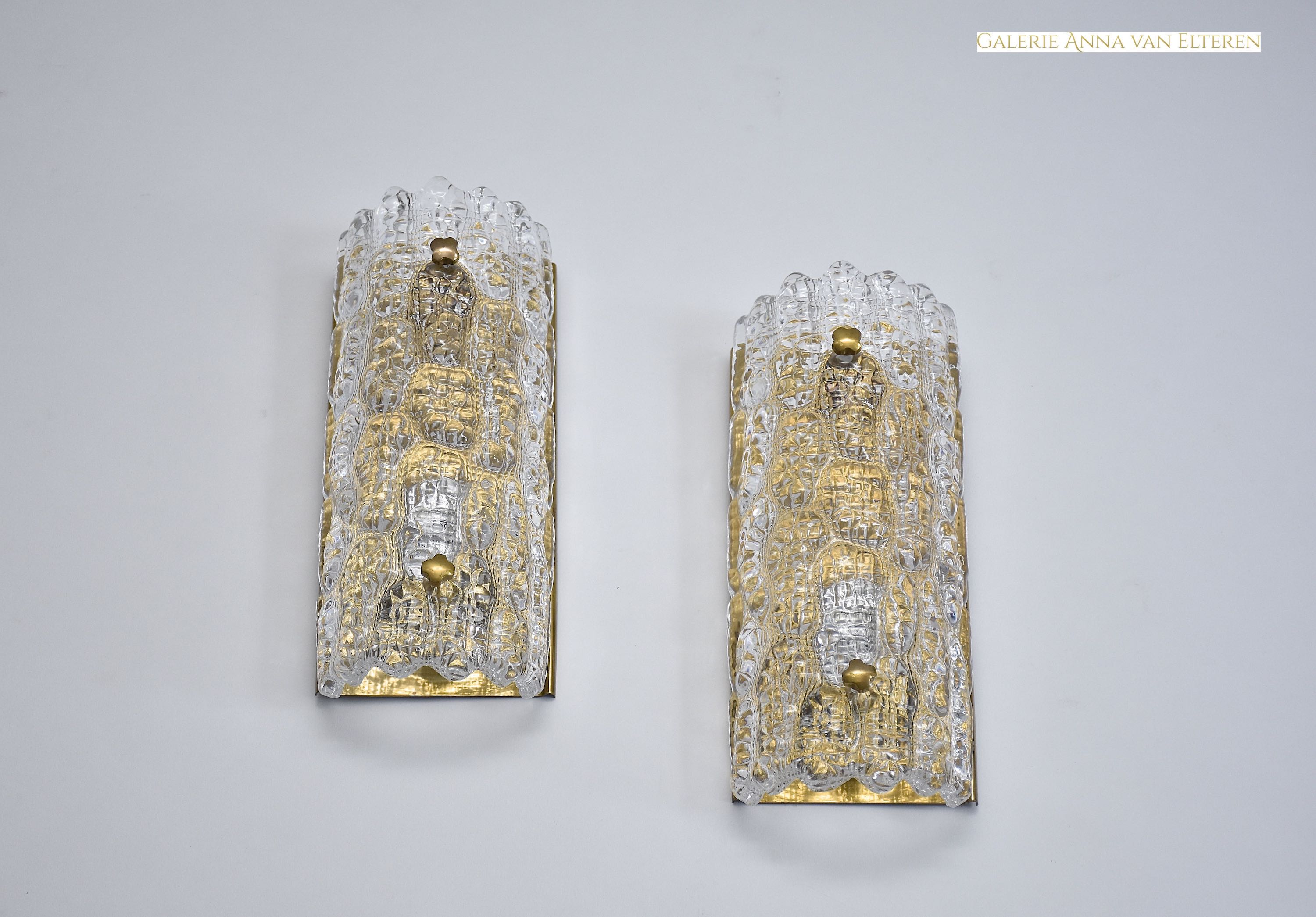 A pair of mid-century glass and brass wall lights by Carl Fagerlund