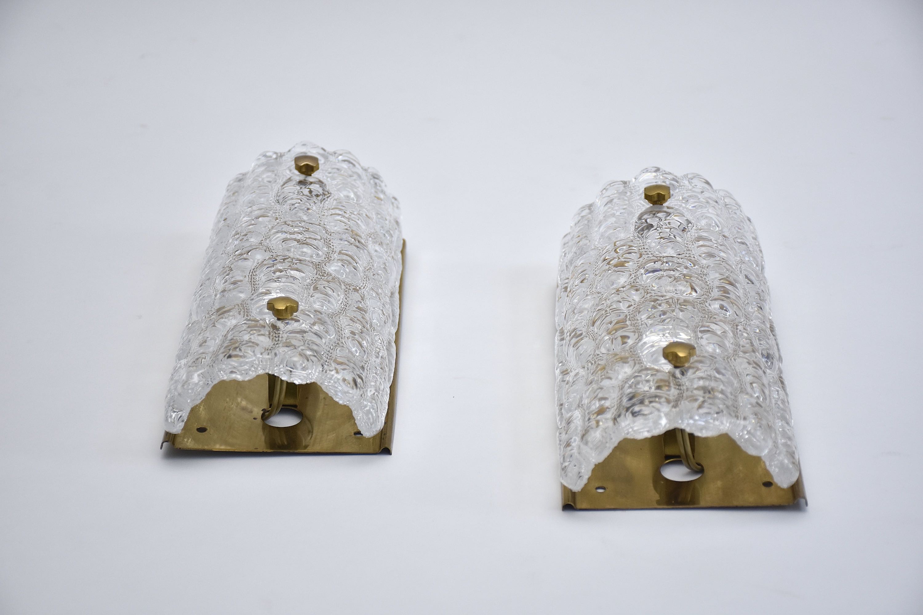 A pair of mid-century glass and brass wall lights by Carl Fagerlund