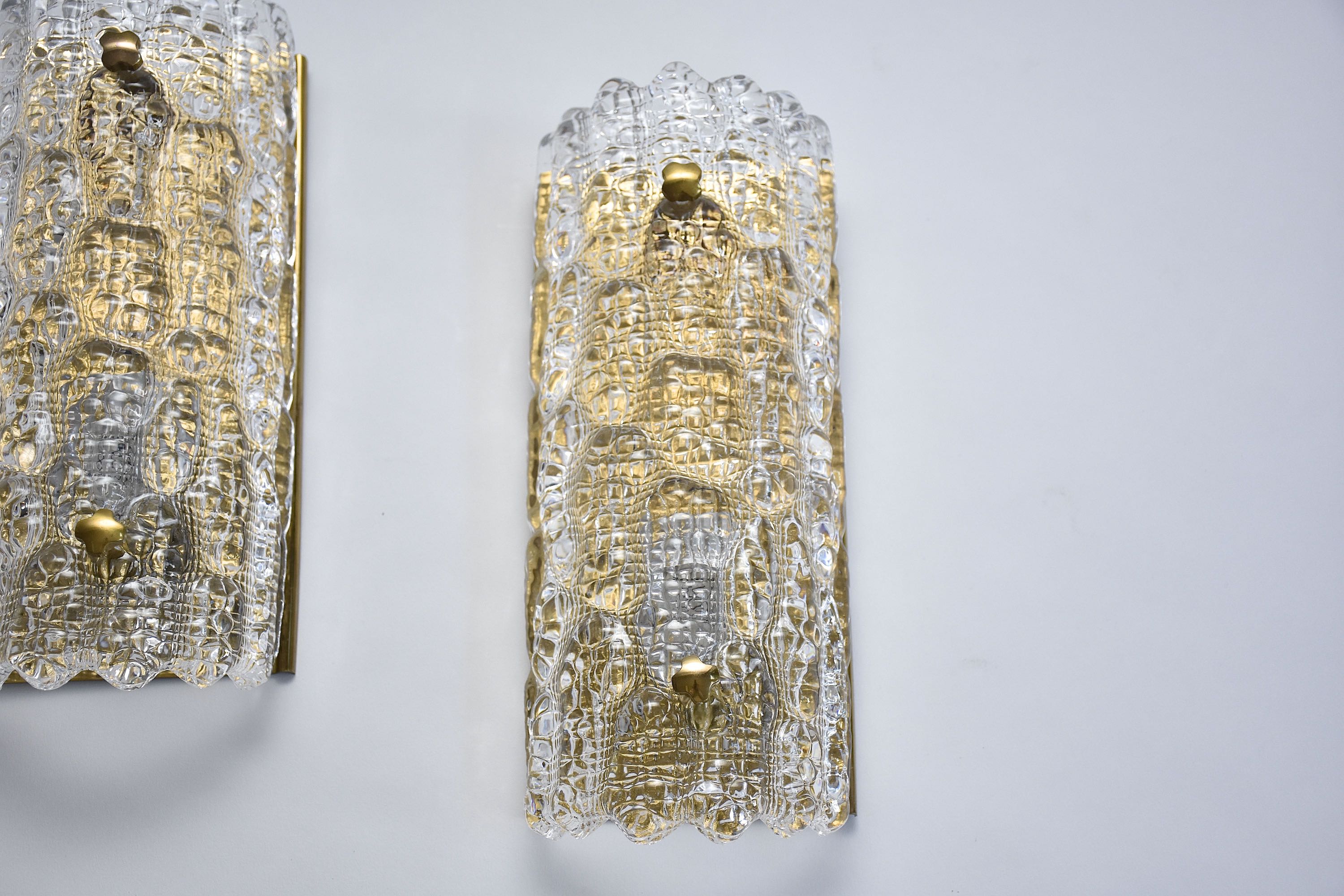 A pair of mid-century glass and brass wall lights by Carl Fagerlund