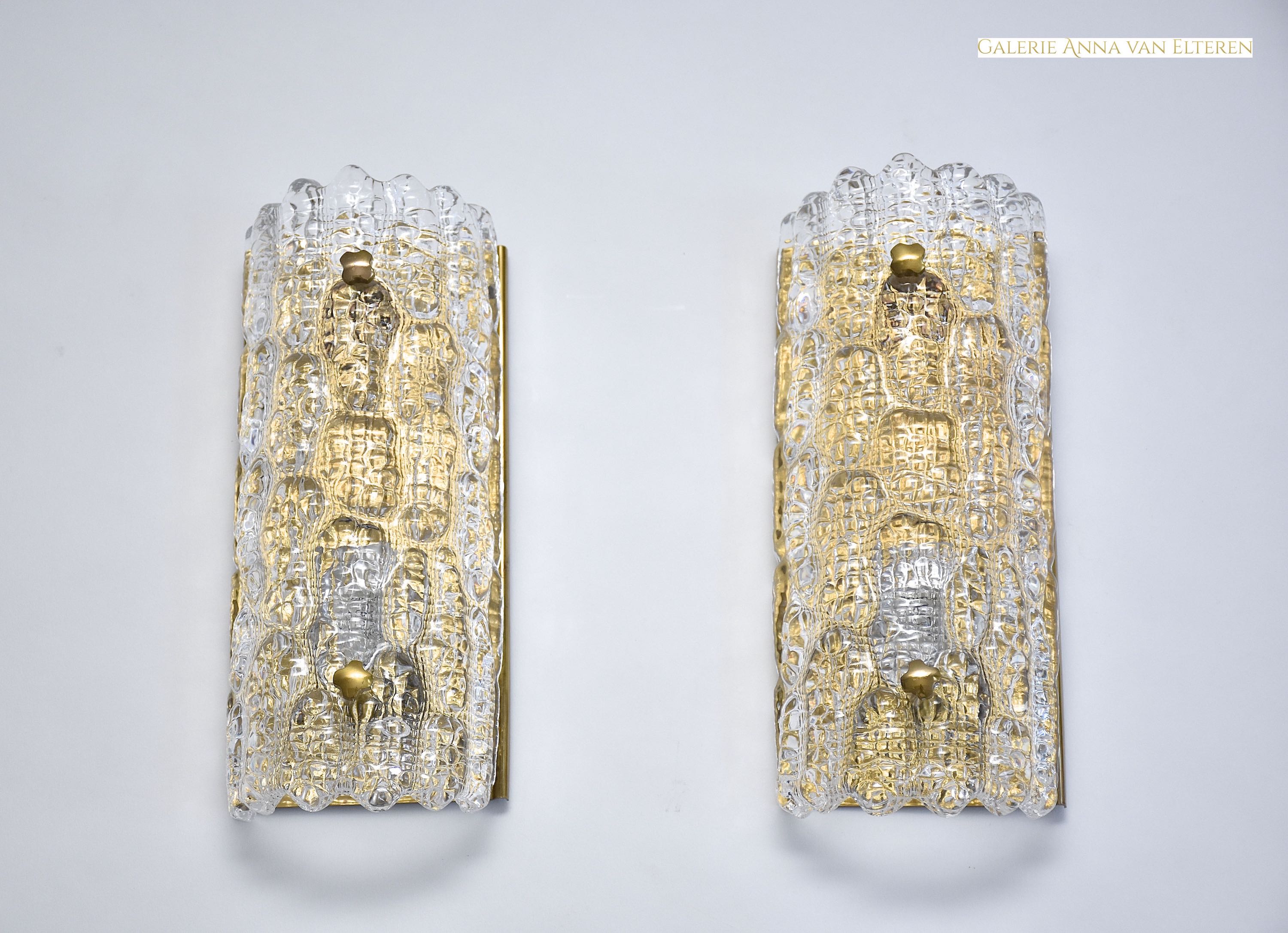 A pair of mid-century glass and brass wall lights by Carl Fagerlund