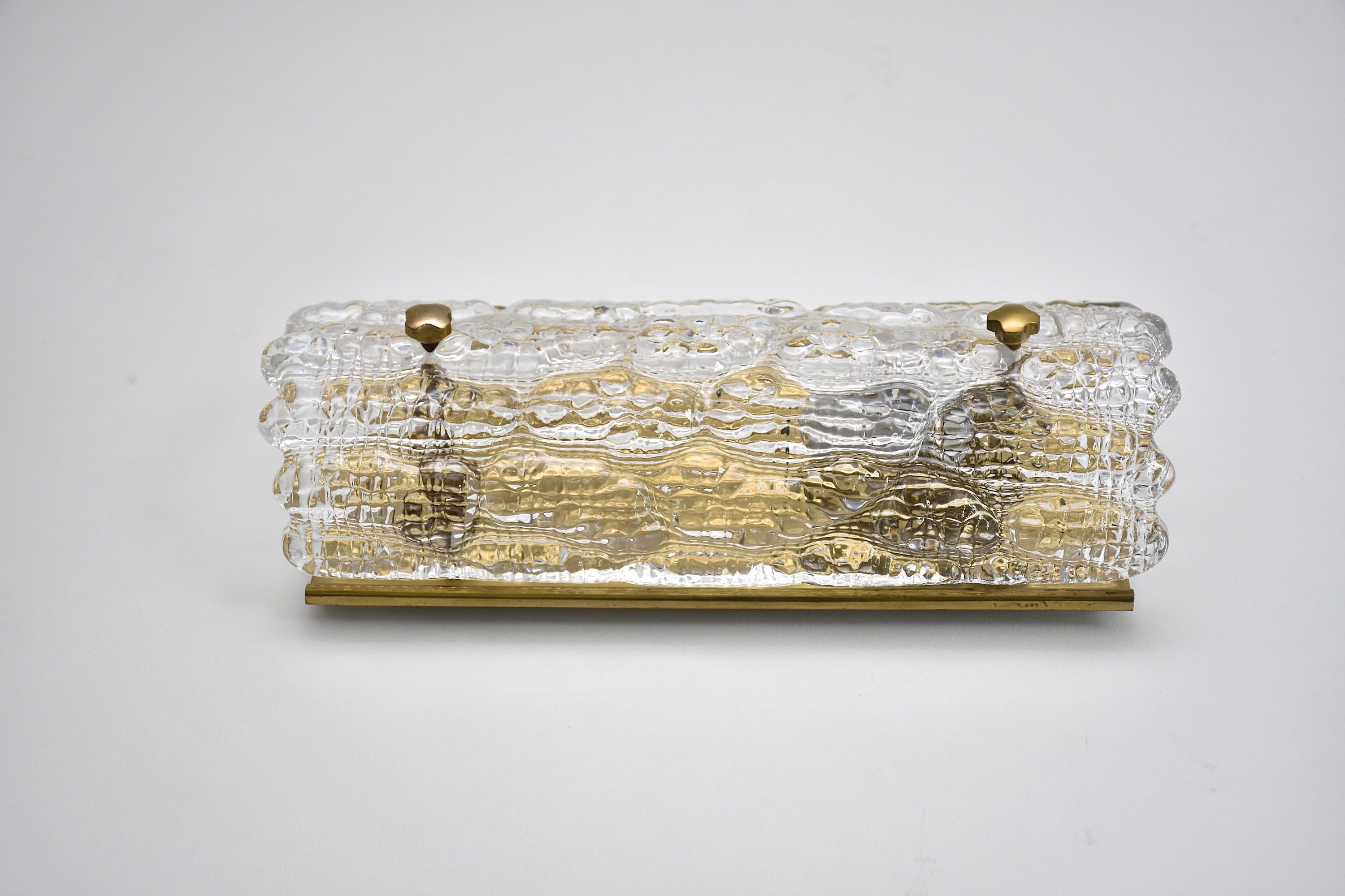 A pair of mid-century glass and brass wall lights by Carl Fagerlund